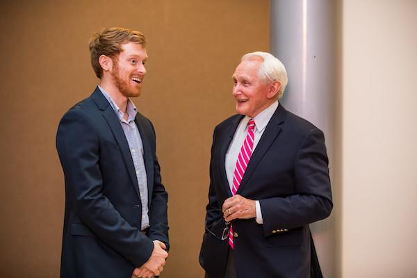 Male business student talking to male entrepreneur.